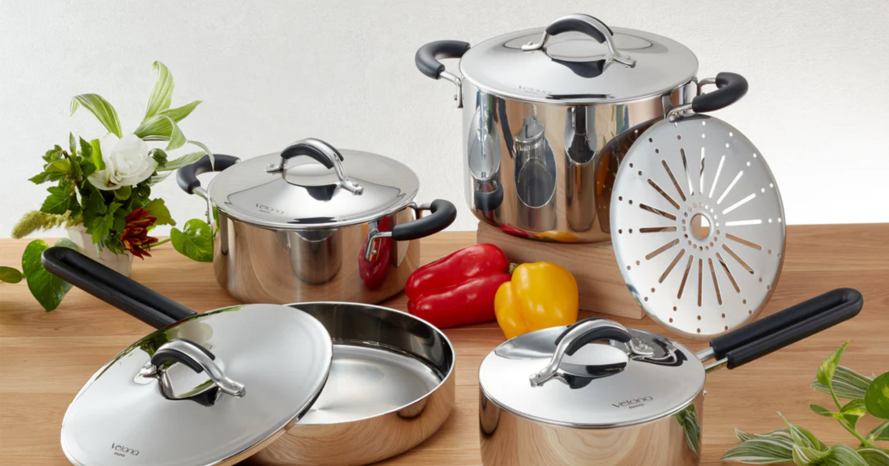 木製の台の上に並べられたステンレス製の鍋やフライパン